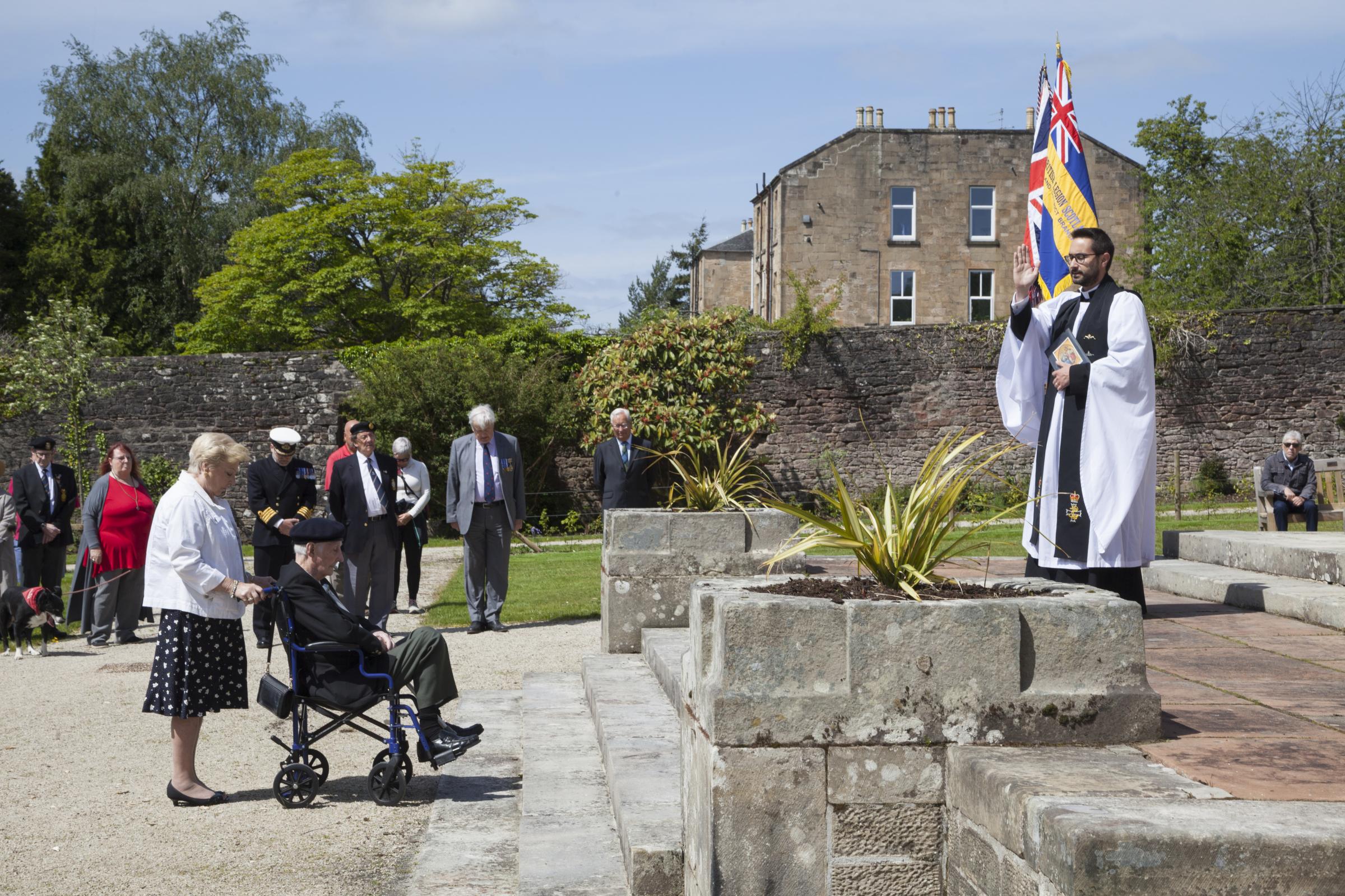 Revd Robert Church leads prayers with Atlantic Star holder Dennis (Spike) Jones and his daughter Diane Carson