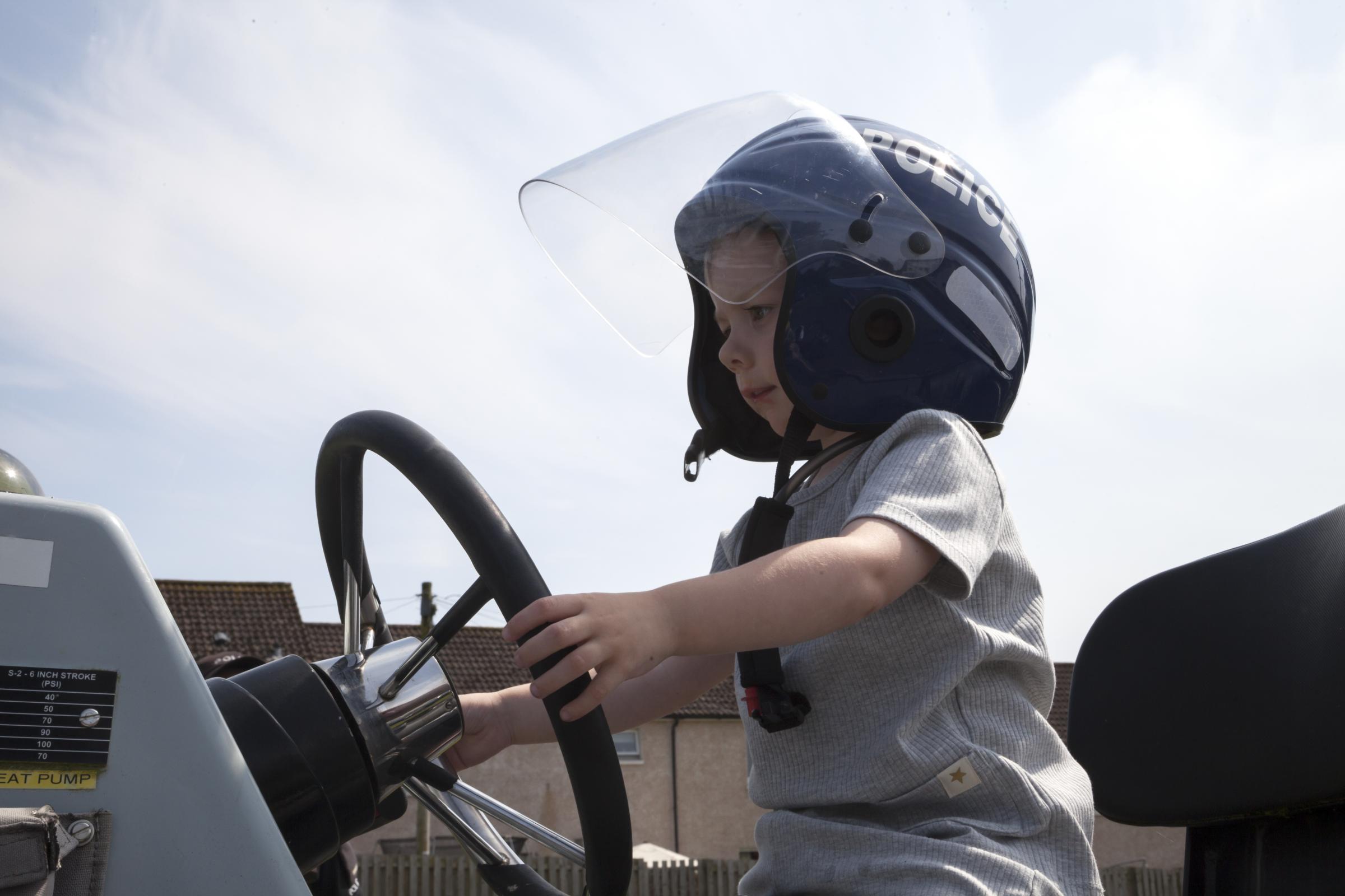 Elijah Braddick on police boat with helmet