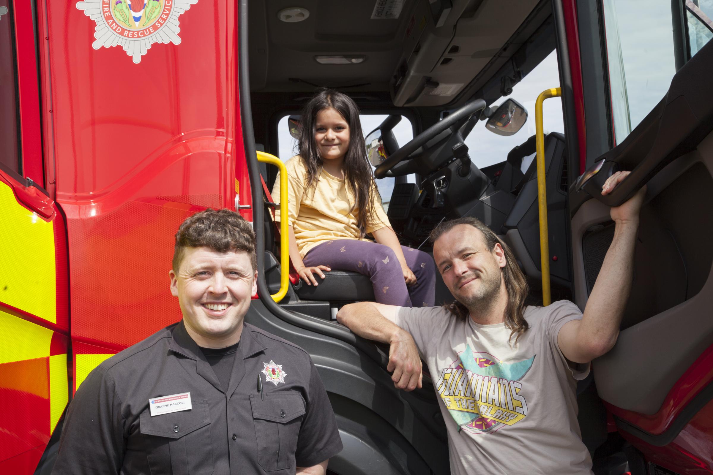 Graeme McColl, Scottish Fire and Rescue Service, with Dinah in the driving seat and her father Adrian