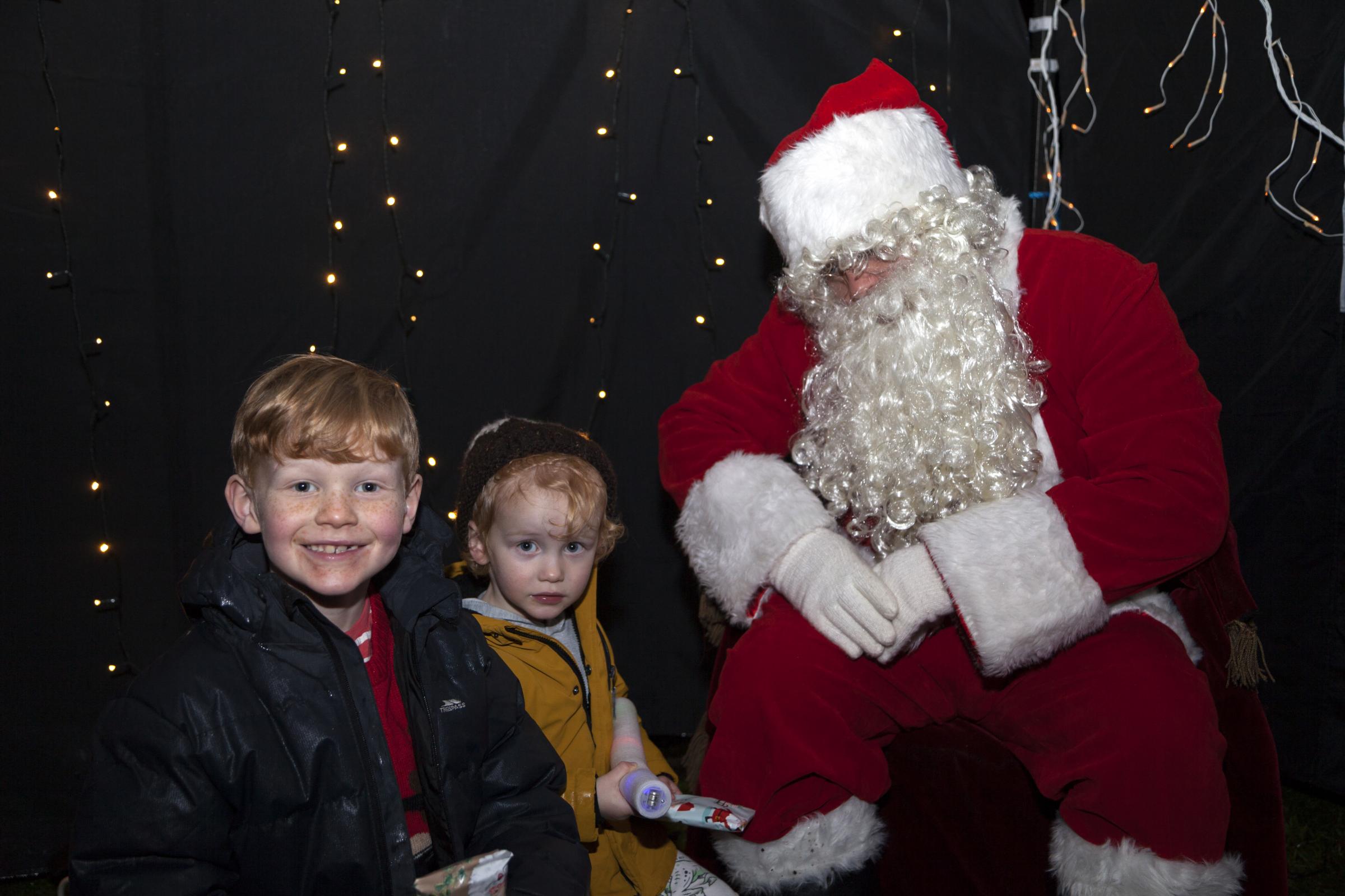 Gabriel Christopher Brearley and Jenson May meeting Santa at Rhu Lights Switch on